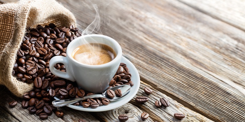 Espresso Coffee Cup With Beans On Vintage Table