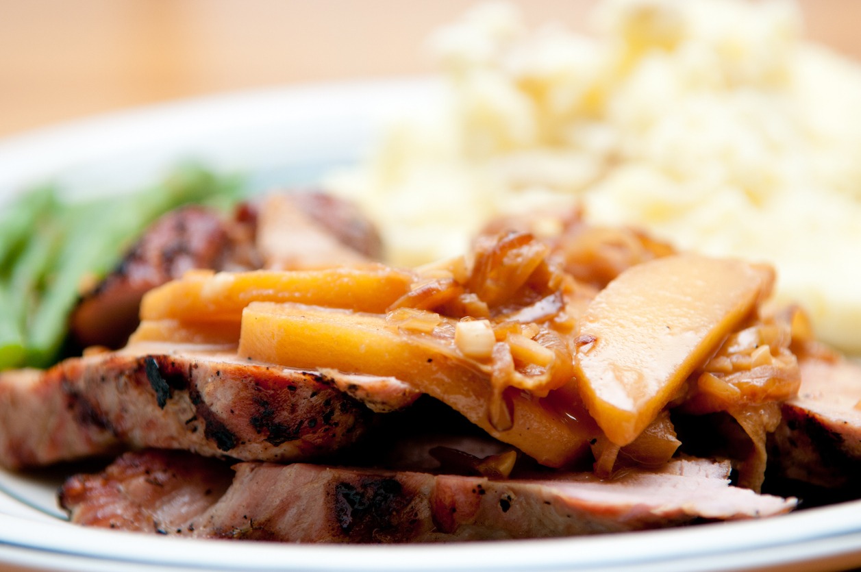 portion-of-mouthwatering-roasted-pork-covered-with-cider-and-chunky-applesauce