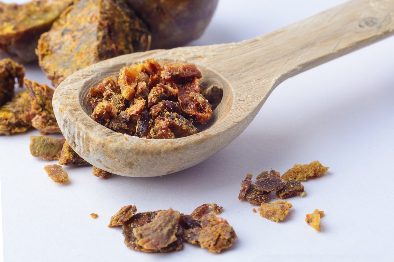 propolis granules on a wooden spoon