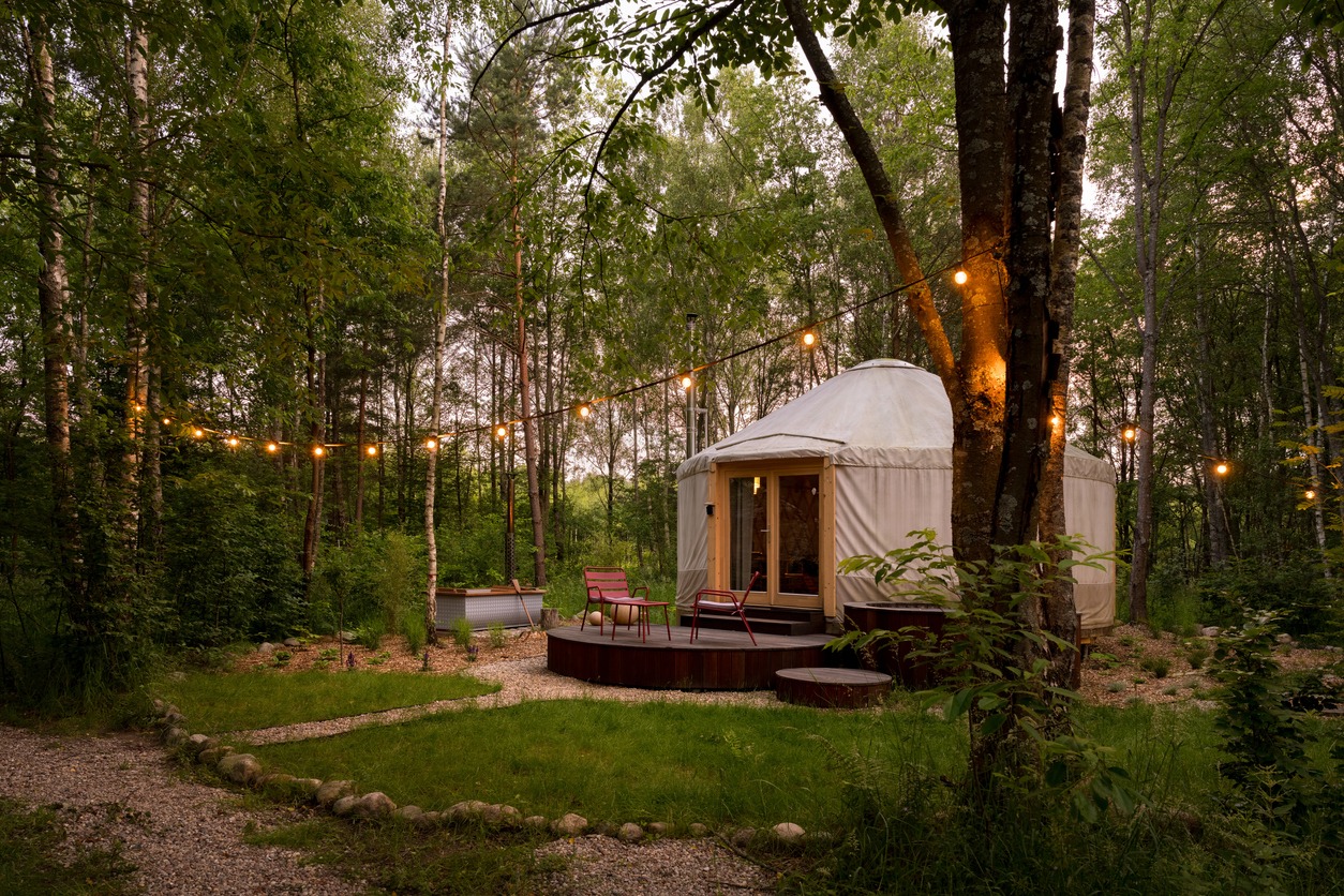a beautiful yurt tent in the middle of a forest