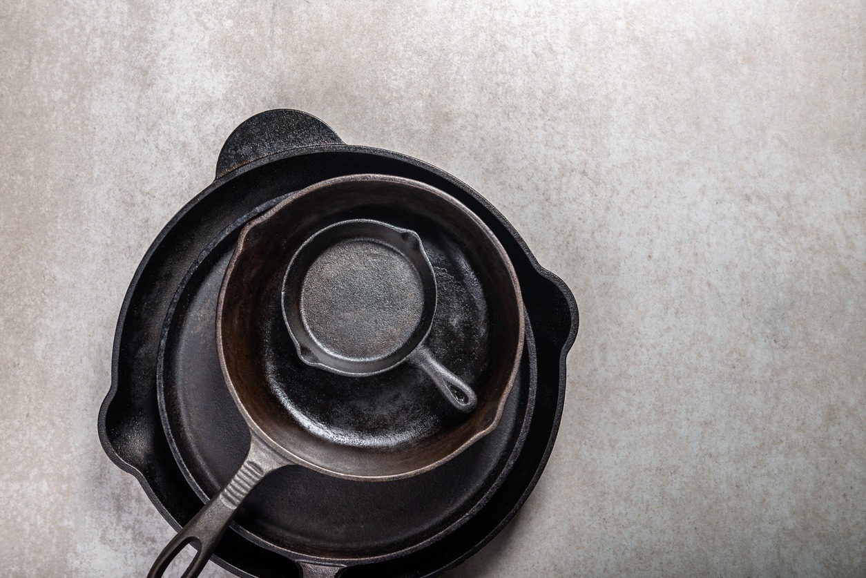 cast iron skillets on a gray background