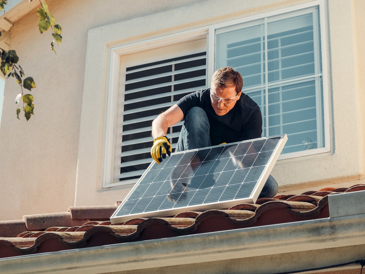 a man installing solar panels on his roof