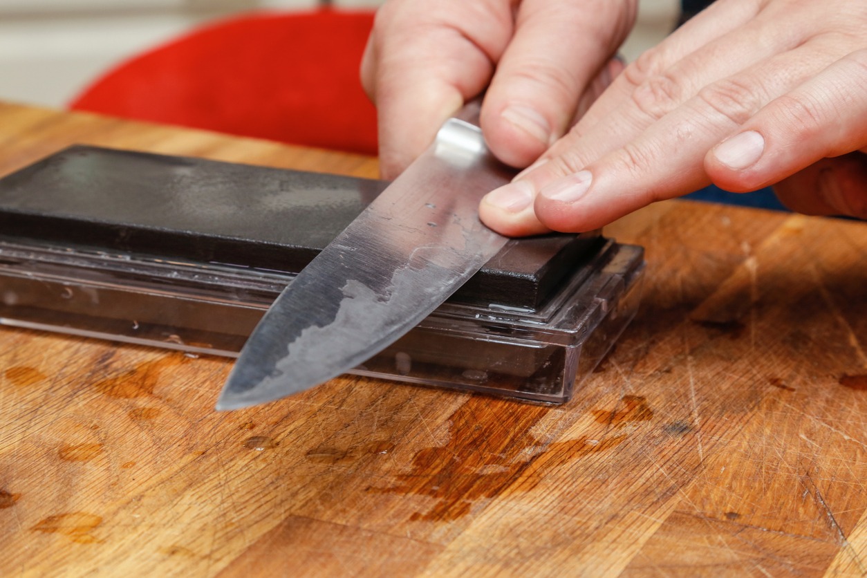 Man sharpening knife