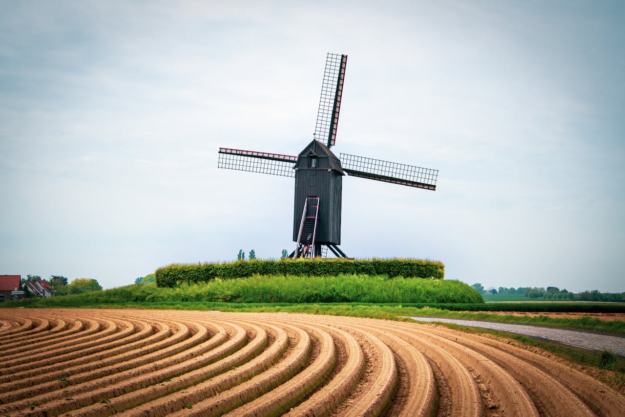 windmill in front of plough land