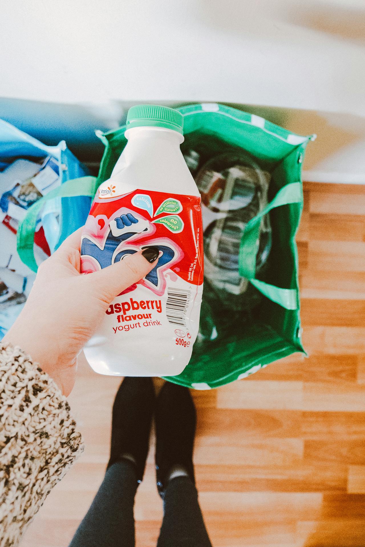 a person holding a disposable bottle