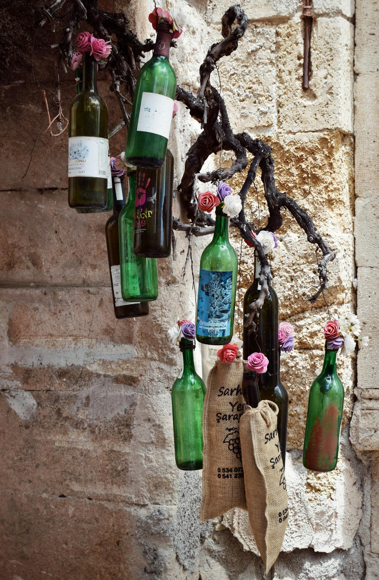 empty wine bottles hanging as decoration on a building
