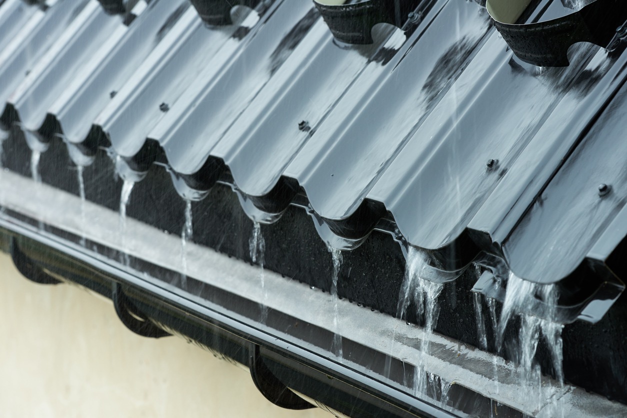 Rainwater flowing down the roof of the roof into the gutter