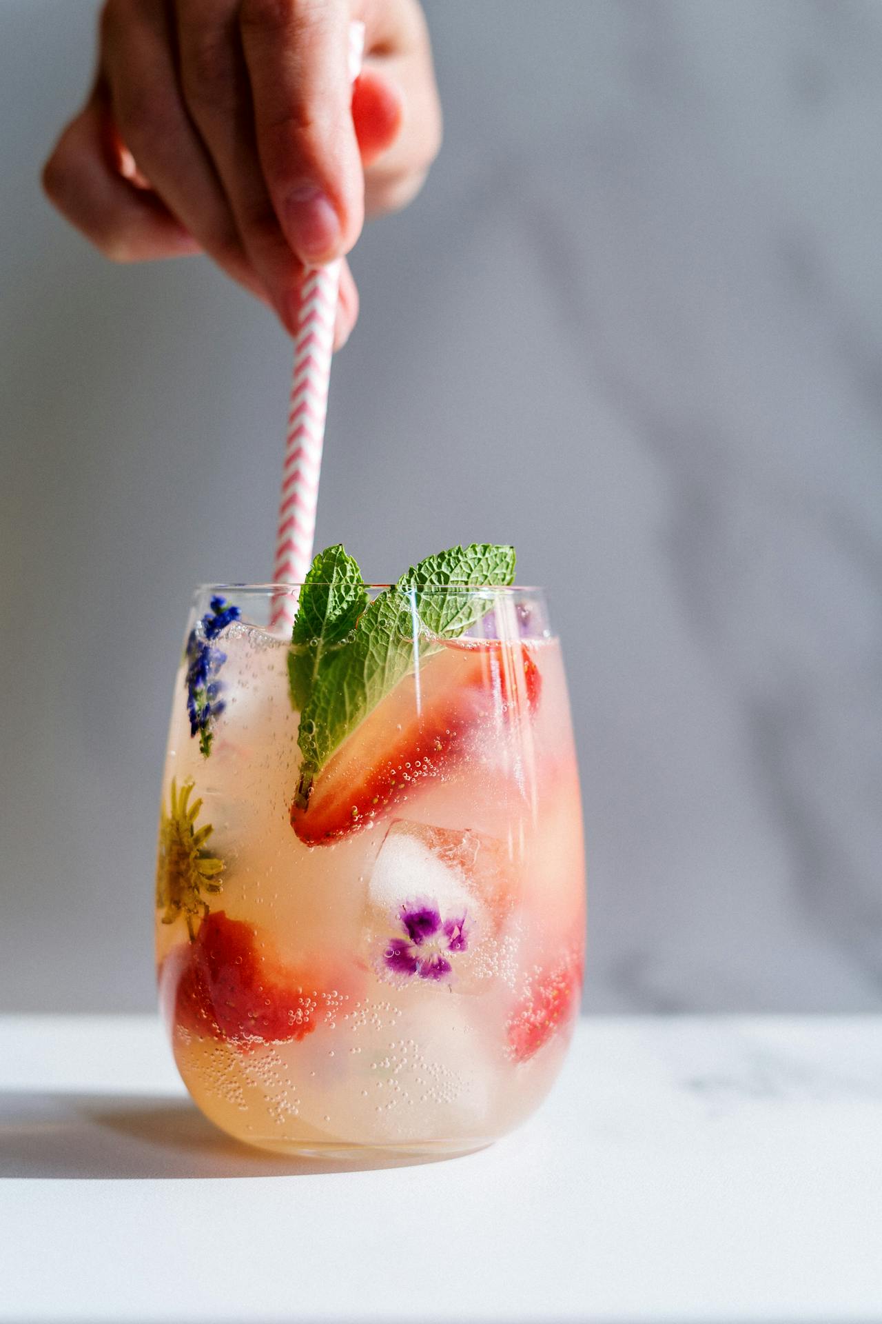 a cocktail with edible flowers