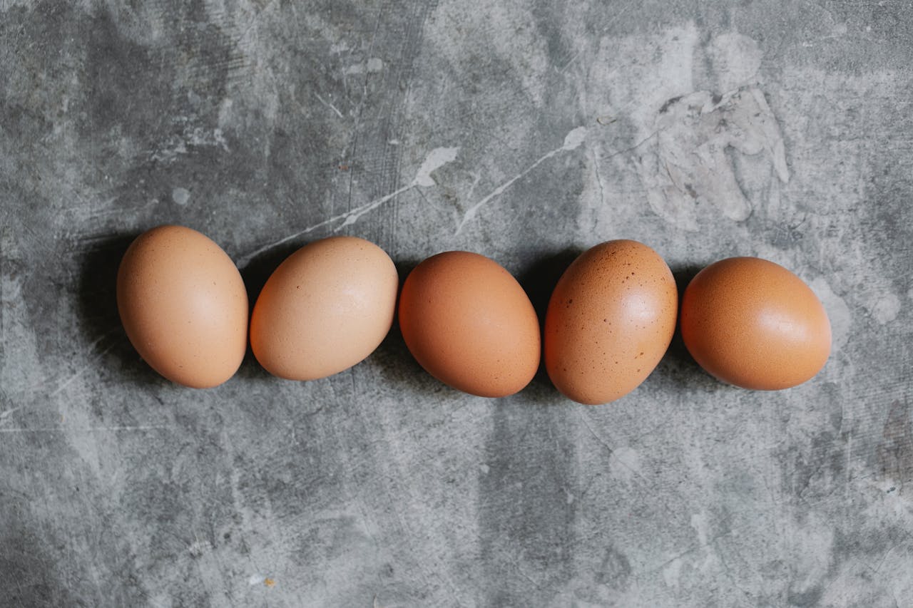 raw brown eggs arranged on a table
