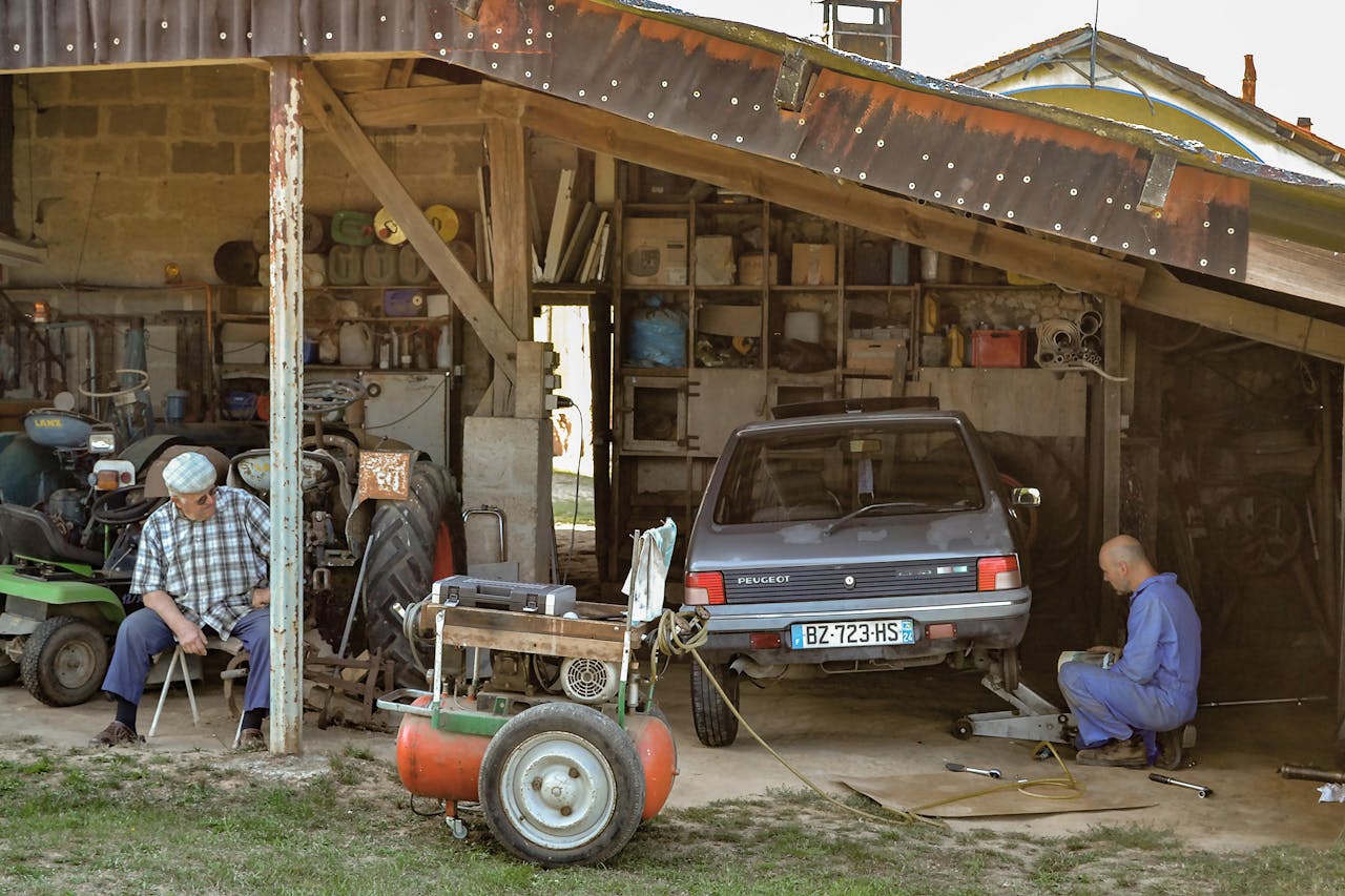 a mechanic using an air compressor in a workshop