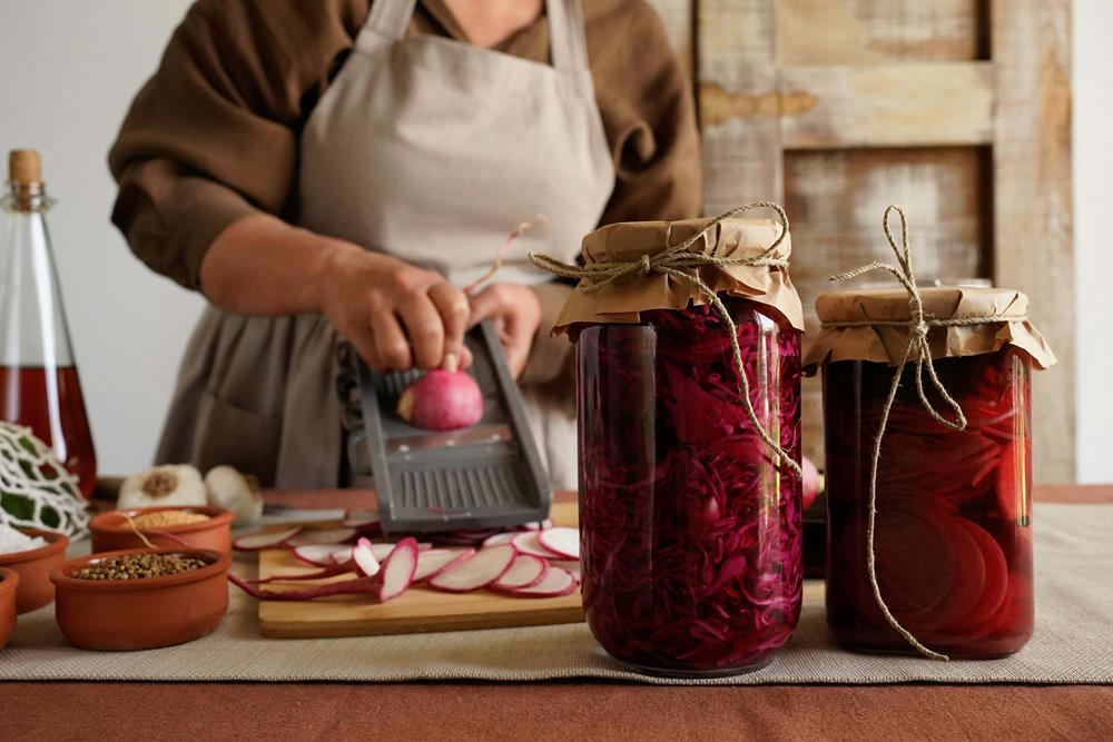 A woman pickling with radishes