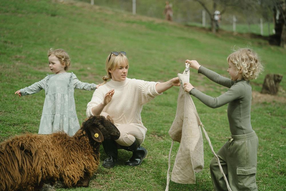 Family on a farm beside sheep