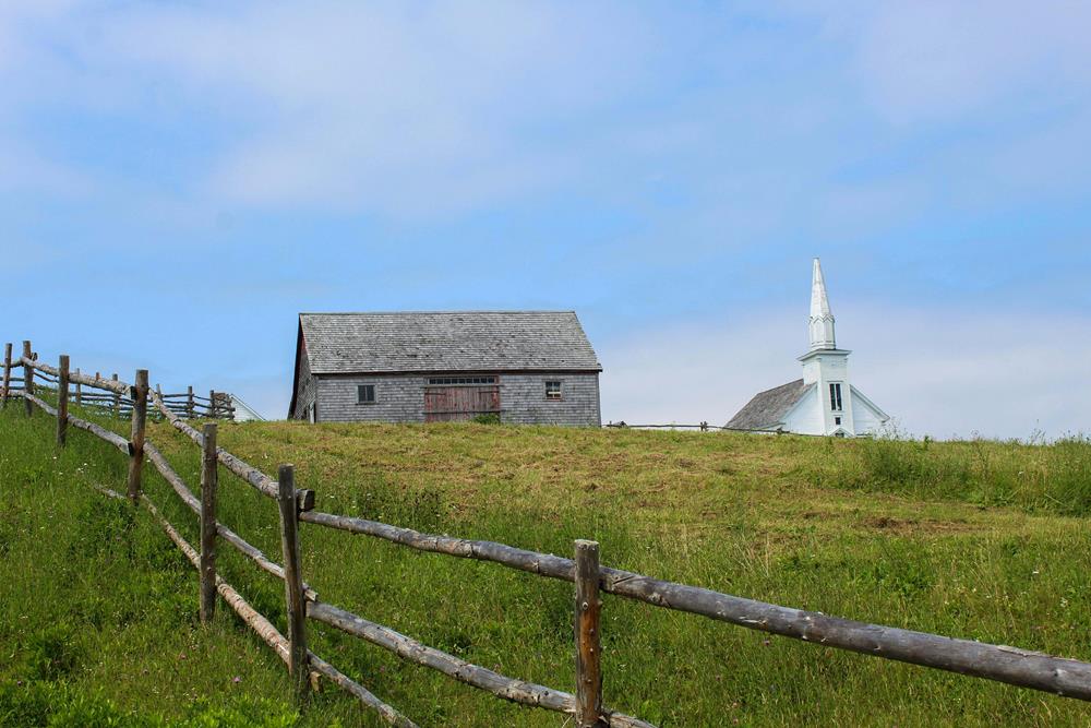Scenic farm with barn and church view