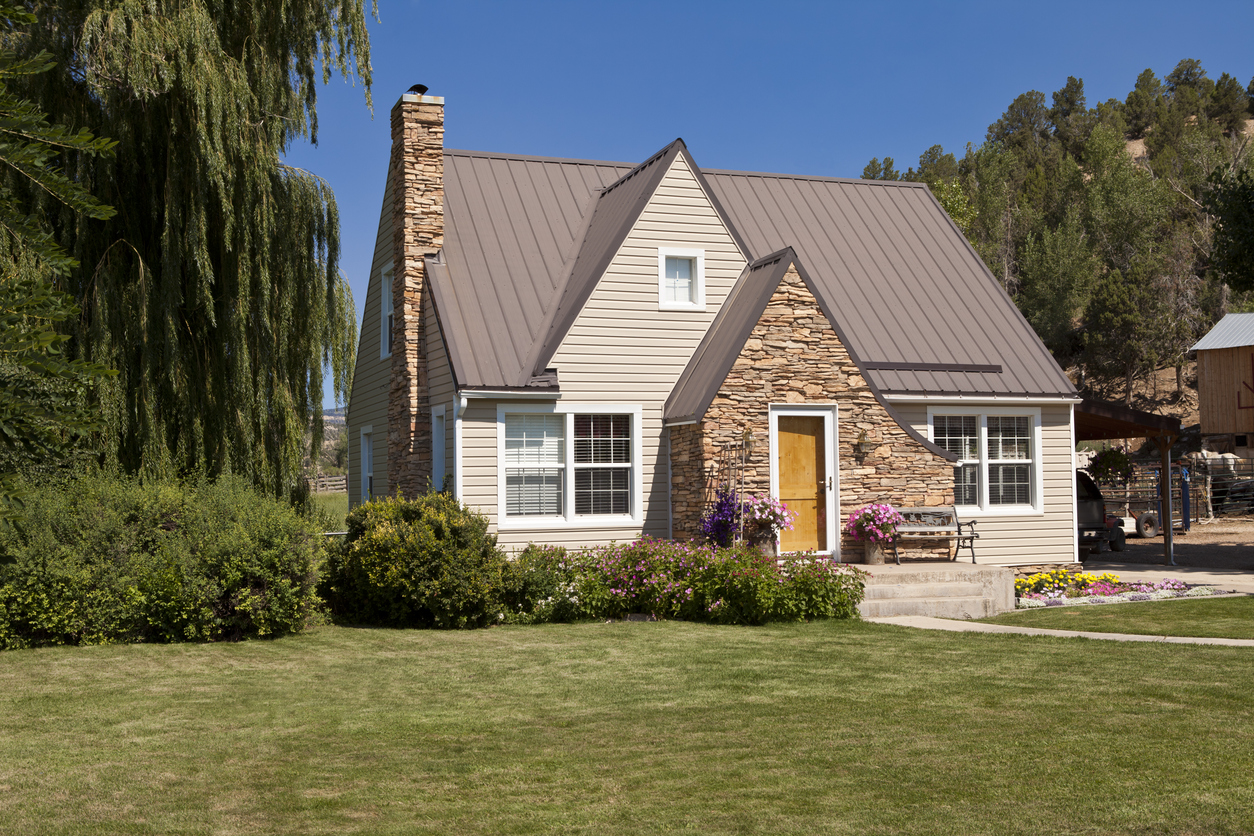Single-family house with green lawn and trees