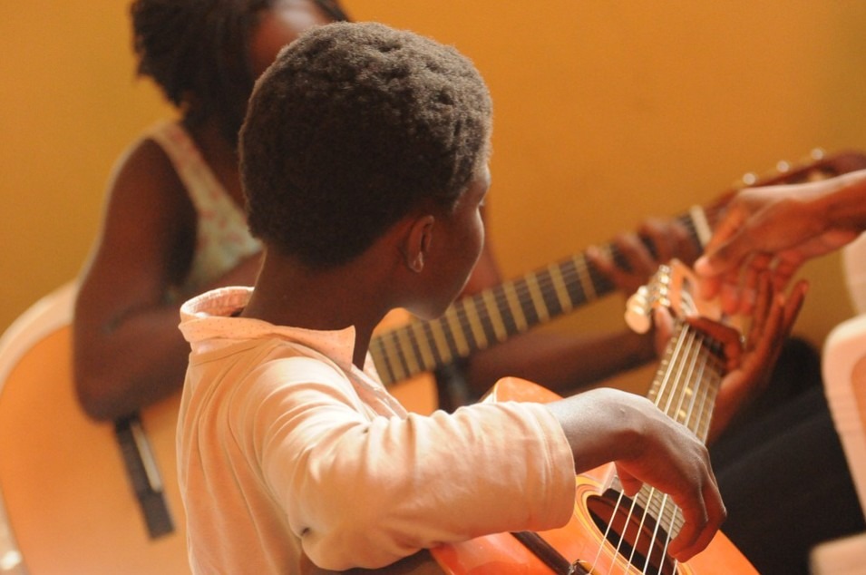 a kid playing the guitar