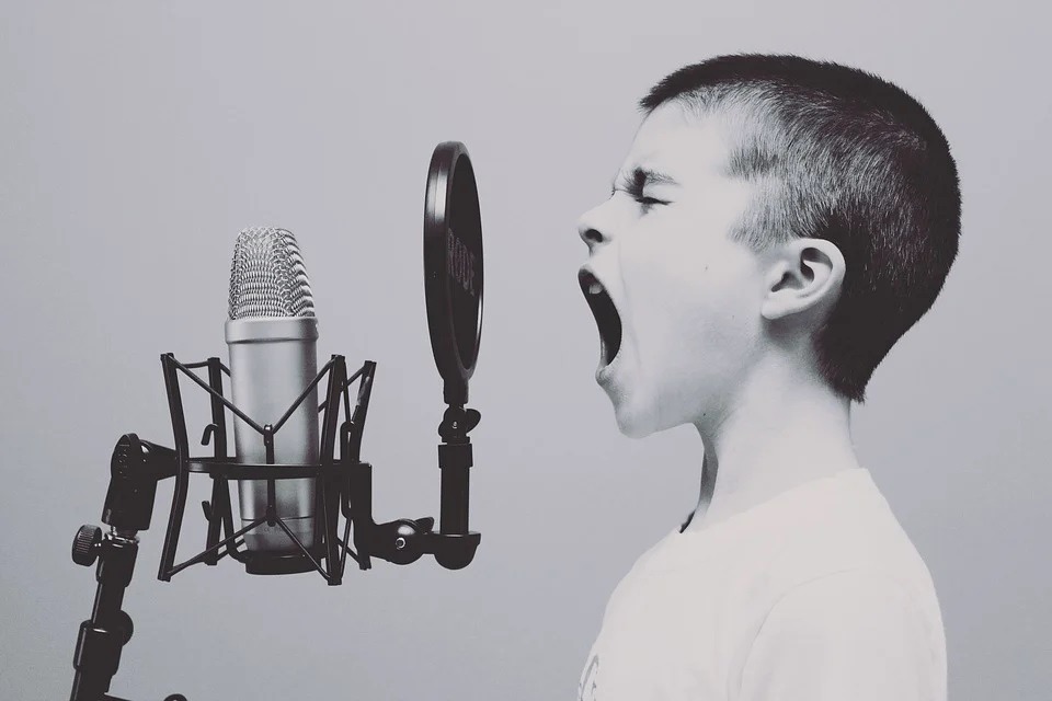 a boy singing, studio microphone