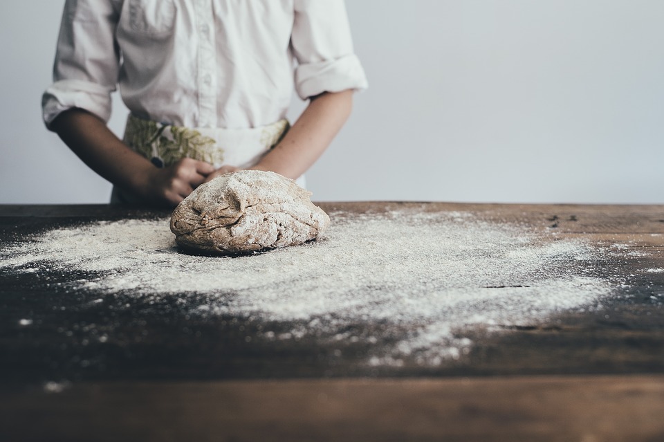 dough, counter, flour, baker wearing an apron