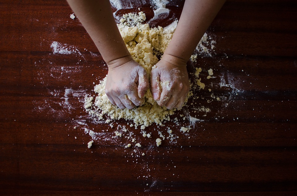 dough, hands kneading the dough, flour