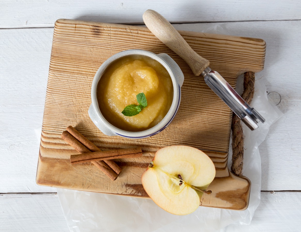 a-small-bowl-of-applesauce-placed-on-a wooden-chopping-board